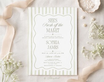 May include: A rectangular bridal shower invitation card featuring sage green vertical stripes and a scalloped border. The text reads: SHE'S Fresh off the MAKET, PLEASE JOIN US FOR A BRIDAL SHOWER HONORING SOPHIA JAMES, MAY 18, 20XX AT 4:00 PM, Amore Bistro.