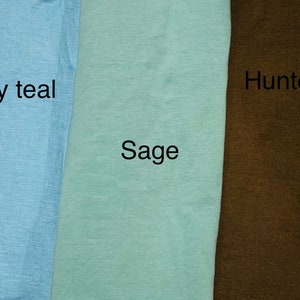 May include: Three fabric swatches in shades of blue, green, and brown. The colors are labeled "Smoky teal", "Sage", and "Hunter". The fabric appears to be a soft, textured material.