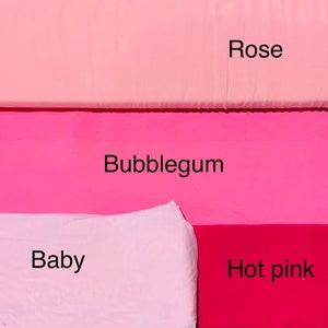 May include: A color palette featuring fabric swatches in shades of pink. The colors are labeled "Rose," "Bubblegum," "Baby," and "Hot pink." The fabrics are arranged in horizontal bands, showcasing the range of pink hues.