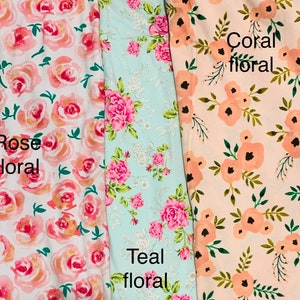 May include: Three floral fabric swatches. The first is white with rose-colored roses and the text "Rose floral". The second is teal with pink roses and the text "Teal floral". The third is peach with coral-colored flowers and the text "Coral floral".