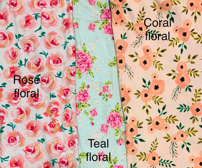 May include: Three floral fabric swatches. The first is white with rose-colored roses and the text "Rose floral". The second is teal with pink roses and the text "Teal floral". The third is peach with coral-colored flowers and the text "Coral floral".