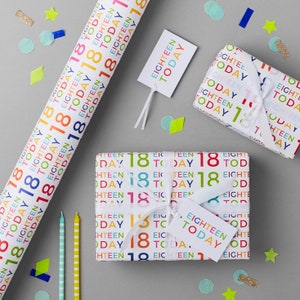 May include: White gift wrap with a colorful repeating pattern of the words "eighteen today" and the number "18". There are two rolls of wrapping paper and a tag that says "eighteen today".