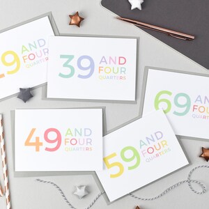 May include: Five greeting cards with a white background and gray borders. Each card features a different number, 29, 39, 49, 59, and 69, with the text "and four quarters" below the number. The numbers are in rainbow colors.
