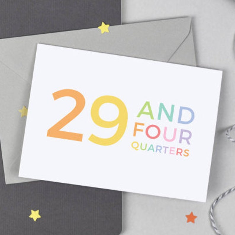 May include: A white card with the number 29 in orange and yellow, and the words "AND FOUR QUARTERS" in rainbow colors.