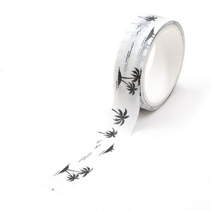 May include: White washi tape with a repeating pattern of black palm trees. The tape is rolled up and partially unrolled, showing the pattern.