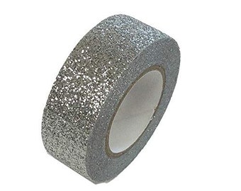 May include: A roll of silver glitter washi tape. The tape is on a white background.