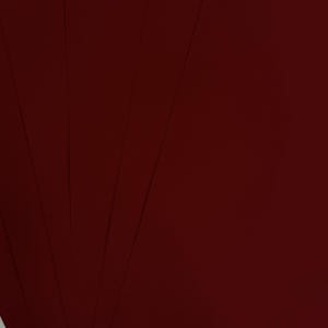 May include: A fan of several sheets of deep burgundy paper. The paper has a smooth, matte finish and is arranged to create a fanned-out effect. The color is a rich, dark red, with subtle variations in tone across the sheets.