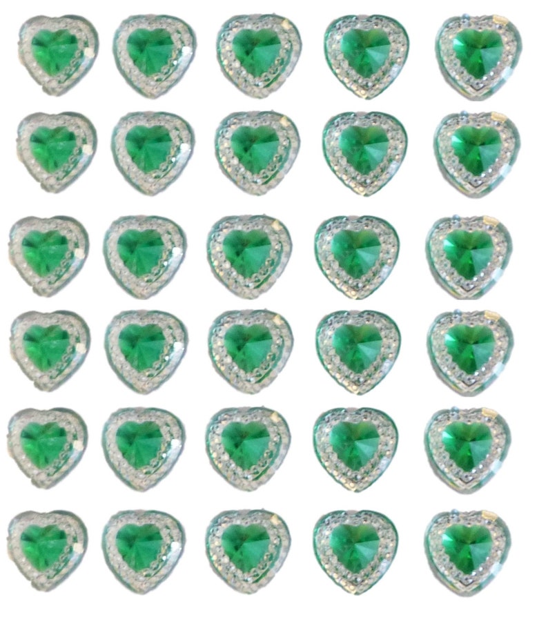 May include: A collection of heart-shaped embellishments. Each heart features a vibrant green center stone surrounded by a border of clear, sparkling rhinestones. The hearts are arranged in a grid pattern against a white background.