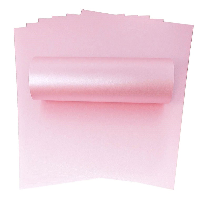 May include: A stack of 12 sheets of light pink shimmery cardstock paper. The paper is rolled up and the edges are visible.