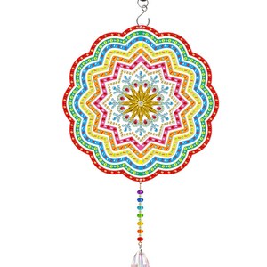 May include: A colorful rainbow mandala with a crystal teardrop hanging from it. The mandala is made of rhinestones and has a snowflake design in the center.