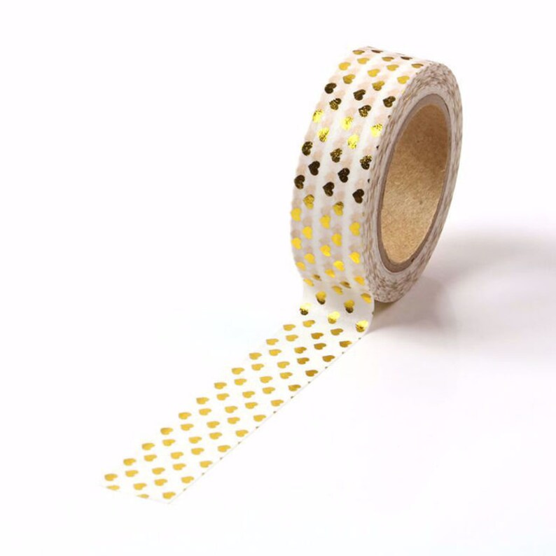 May include: A roll of white washi tape with a gold heart pattern.