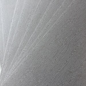 May include: Close-up of a gray wood-grain pattern. The design features diagonal lines with knots, creating a textured surface. The color is a neutral gray, suitable for various design applications.