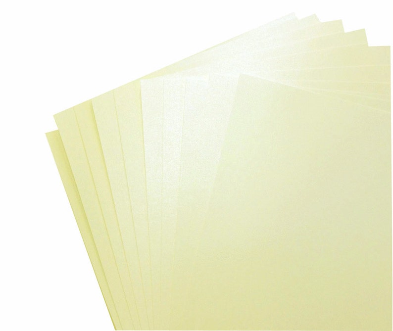 May include: A stack of eight sheets of pale yellow cardstock paper.