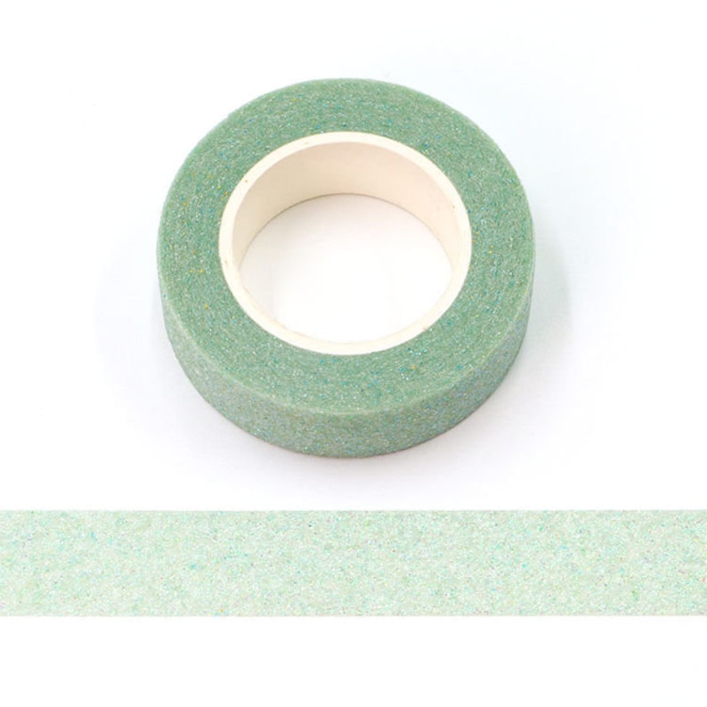 May include: A roll of green floral tape with a glittery finish. The tape is wound around a cardboard core.