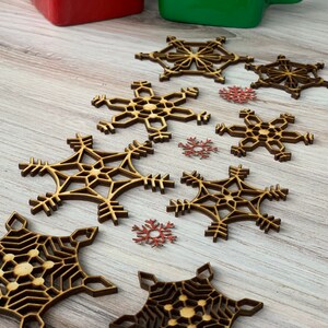 Eight Rustic snowflake ornaments 2 inches to 3 inches in size.