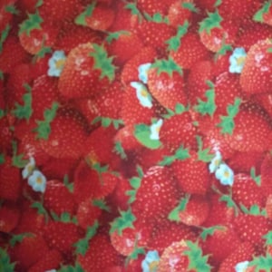 May include: A close-up image of a red and green fabric with a repeating pattern of strawberries. The strawberries are arranged in a random pattern and are surrounded by green leaves.