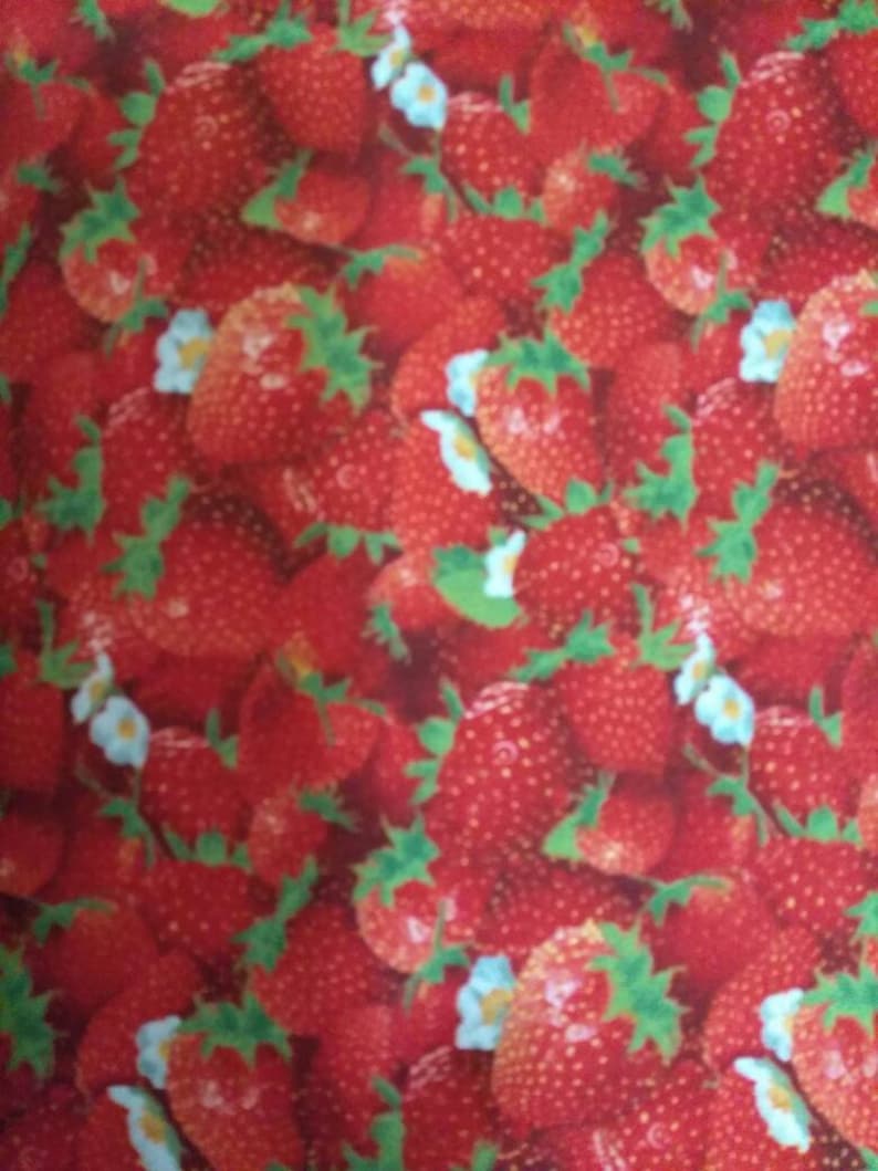 May include: A close-up image of a red and green fabric with a repeating pattern of strawberries. The strawberries are arranged in a random pattern and are surrounded by green leaves.