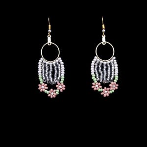 May include: A pair of dangle earrings with a silver and white beaded hoop and pink and green flower accents.