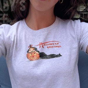 Cute Halloween baby tee shirt featuring a girly pumpkin design, perfect for a 90s aesthetic Halloween look
