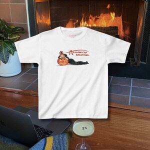Cute Halloween baby tee with an adorable pumpkin graphic, ideal for a girly and trendy Halloween style