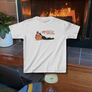 Girly Halloween baby tee shirt with a cute pumpkin design, capturing a 90s aesthetic for Halloween