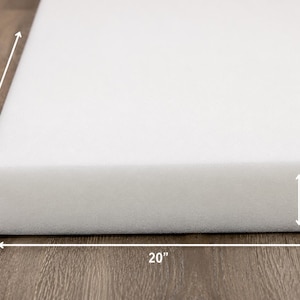 May include: A rectangular white foam cushion block with a smooth, uniform texture. The dimensions are clearly marked with arrows and text, indicating a length of 40 inches, a width of 20 inches, and a thickness of 2 inches for this foam piece.