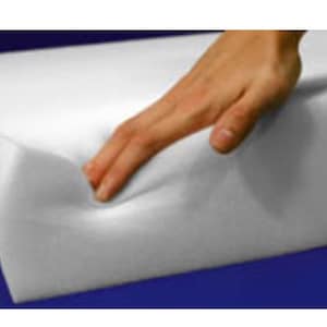 May include: A white foam cushion with a hand pressing into it, demonstrating its softness and resilience.