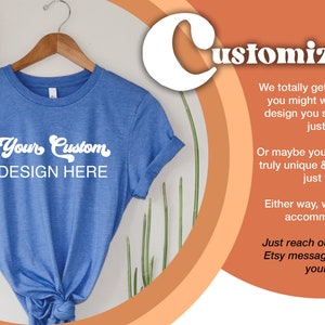 Pu&ograve; includere: Una maglietta blu con il testo "Your Custom DESIGN HERE" su di essa. La maglietta &egrave; appesa a un appendiabiti di legno. Lo sfondo &egrave; color pesca con la parola "Customization" in bianco.