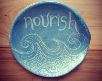 spoon rest sky blue with waves and word "NOURISH"