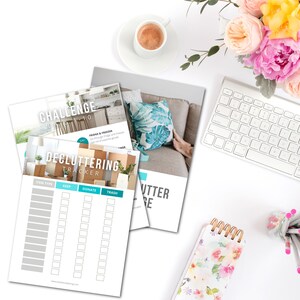 May include: A printable decluttering tracker checklist with columns for item type, keep, donate, and trash. The tracker is designed to help people declutter their homes. The image also shows a challenge card with the text "Challenge Day 1 of 10" and a list of tasks to complete.