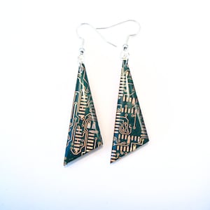 May include: A pair of green and gold triangle-shaped earrings made from recycled circuit boards. The earrings have silver hooks.