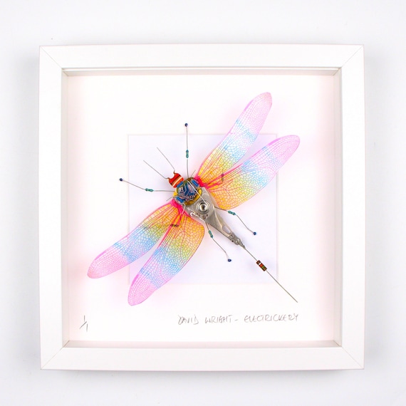 A framed dragonfly sculpture whose wings are meticulously assembled from salvaged circuit board traces — 130 favorites confirm this is the real deal.