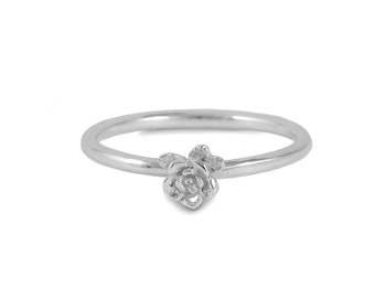 May include: A delicate silver ring featuring a small, detailed rose design.