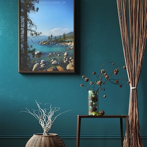 May include: A framed photograph of a lake with a tree in the foreground and mountains in the background. The lake is a light blue color and the mountains are a dark blue color. The tree is a dark green color and the sky is a light blue color. The photo is hanging on a teal wall with a brown wicker basket and a small table with a vase of dried branches.