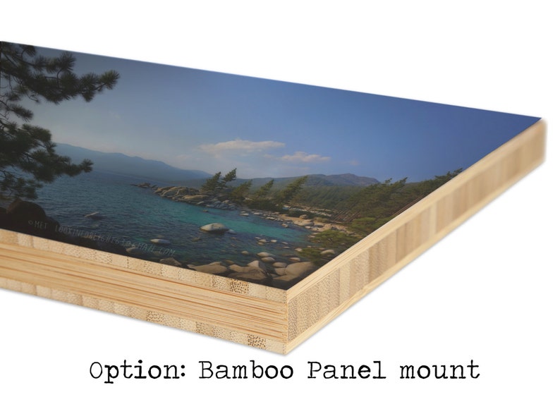 May include: A close-up of a bamboo panel mount with a printed image of a lake and mountains. The image is printed on a smooth surface and the bamboo panel is made of multiple layers of wood.