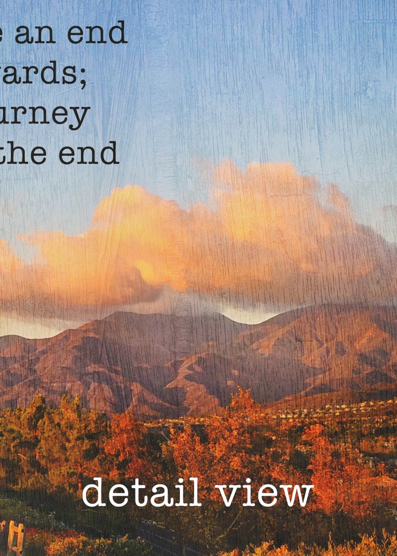 May include: A photograph of a mountain range with a large, fluffy cloud in the sky. The mountains are brown and the sky is blue. The text "There an end towards; journey to the end" is at the top of the image. The text "detail view" is at the bottom of the image.