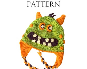 Könnte beinhalten: Ein Häkelmuster für eine grüne Monstermütze mit orangefarbenen und schwarzen Akzenten. Das Muster ist als PDF-Download erhältlich. PATTERN PDF DOWNLOAD