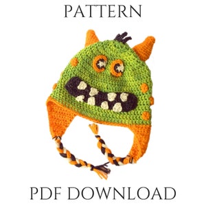 Puede incluir: Un patrón de crochet para un gorro de monstruo verde con detalles naranja y negro. El patrón está disponible para descargar en PDF. PATTERN PDF DOWNLOAD