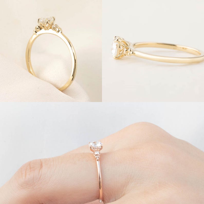 May include: A delicate gold ring with a round center stone and smaller accent stones on the band.