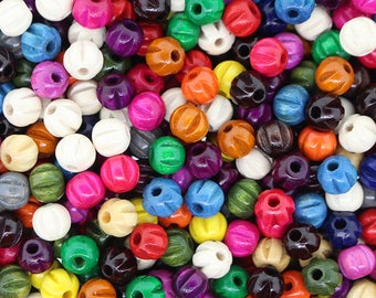 May include: A large assortment of colorful wooden beads with a hole through the center. The beads are round and have a textured surface.
