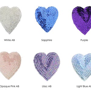 May include: Six heart-shaped sequins in various colours, including white, sapphire, purple, opaque pink, lilac, and light blue. Each heart is approximately 5 cm in diameter.