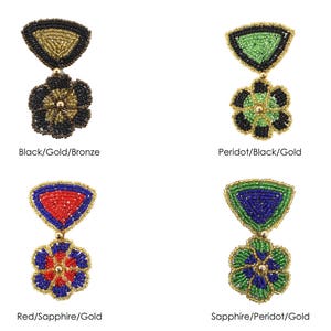 May include: Four pairs of beaded earrings with a flower design. Each pair features a different color combination: black, gold, and bronze; peridot, black, and gold; red, sapphire, and gold; and sapphire, peridot, and gold.
