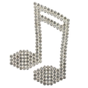 May include: A silver musical note made of small, round rhinestones.