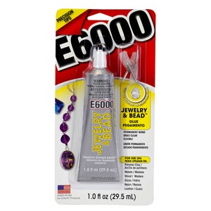 May include: E6000 Jewelry & Bead glue in a silver tube with a black and red label. The packaging includes a small pair of precision tips and a graphic of a beaded necklace. The tube contains 1.0 fl oz (29.5 ml) of glue.