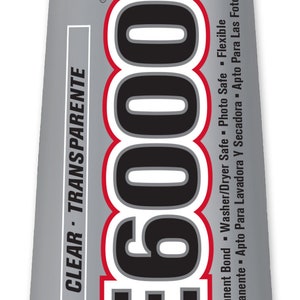 May include: A tube of E6000 industrial strength adhesive. The silver tube has a white cap and features the product name in large black letters with a red outline. The tube contains 3.7 fl oz of clear, transparent adhesive.