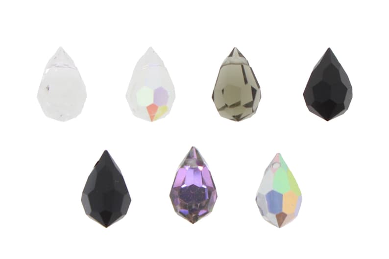 May include: Assortment of teardrop-shaped crystal beads in various colors, including clear, iridescent, black, and gray.