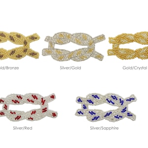 May include: Six different color variations of a beaded rope knot design. The knots are made with gold, silver, bronze, red, crystal, and sapphire beads.