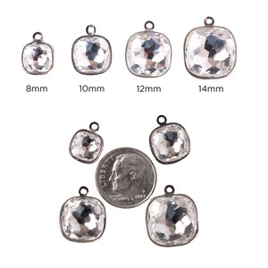 May include: Assortment of clear crystal square charms with silver settings in various sizes: 8mm, 10mm, 12mm, and 14mm. The charms are shown next to a US dime for size comparison.