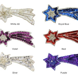 May include: Assortment of six shooting star iron-on patches in various colors, including white, royal blue, violet, red, silver, and purple. Each patch features a star with a tail of sequins.