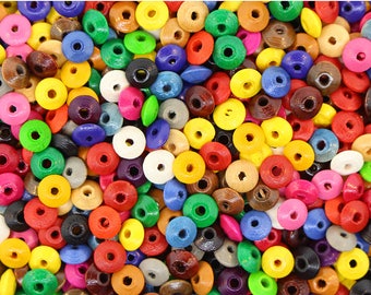 May include: A large assortment of colorful wooden beads with a hole in the center. The beads are in various shades of red, blue, green, yellow, orange, pink, purple, brown, and white.